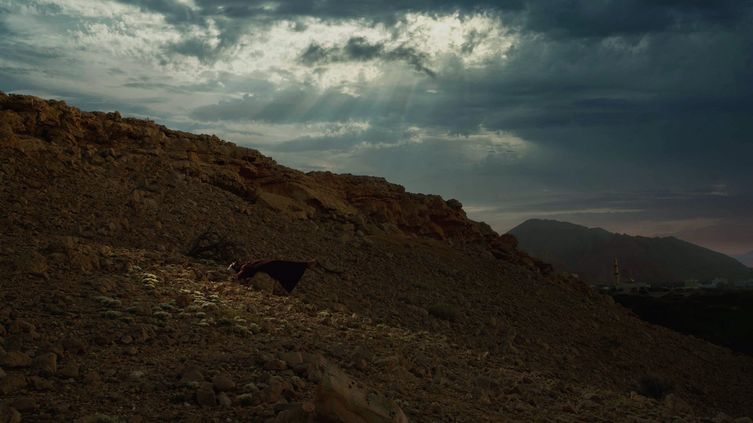 Awakening: a figure looking skyward beneath the clouds of Oman — Omani photographer AMRALI, AA Editions